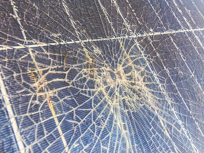 A solar panel damaged by hail