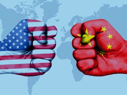 An American fist is dueling with a Chinese one as they battle for global supremacy