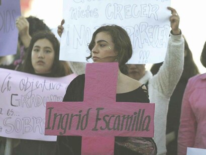 Signs and a banner to commemorate victims from femicide in Mexico