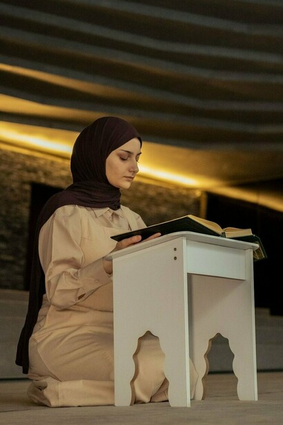 A devoted student studying sacred scripture, reflecting the tradition of faith-centered learning