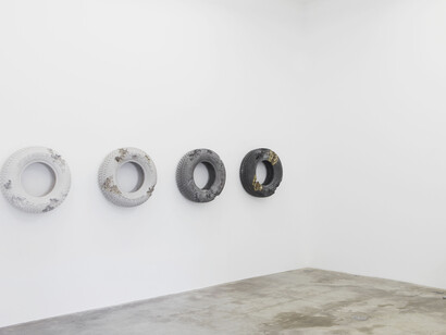 From left to right: “Rose Quartz Eroded Tire” 2014, Rose quartz, marble dust, hydrostone, 75 x 75 x 25 cm / 29 1/2 x 29 1/2 x 9, 3/4 inches & “Glacial Rock Eroded Tire” 2014, Glacial rock dust, marble dust, hydrostone, 75 x 75 x 25 cm.29 1/2 x 29 1/2 x 9 3/4
inches, & “Obsidian Eroded Tire” 2014, Obsidian fragments, ground glass, hydrostone, 75 x 75 x 25 cm / 29 1/2 x 29 1/2 x 9 3/4 inches, & “Steel Eroded Tire” 2014, Steel fragments, volcanic glass, hydrostone, 75 x 75 x 25 cm / 29 1/2 x 29 1/2 x 10 inches, & “Glacial Rock Eroded Hollow Guitar” 2014, Glacial rock dust,
fragments of marble, hydrostone, 105 x 38 x 7,5 cm / 41 1/4 x 15 x 2 3/4, inches. Photo : Claire Dorn, Courtesy Galerie Perrotin