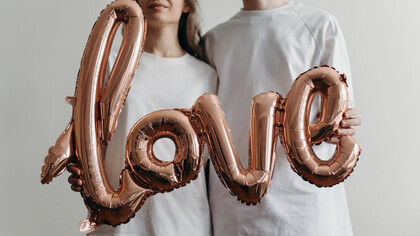 Love sign adorned with heart-shaped balloons