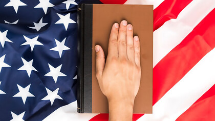 Top view hand on book and american flag