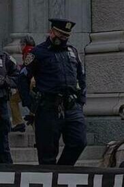 Policeman at a gathering in favor of asylum seekers, New York City, 2020