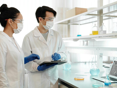 A man and a woman working as scientists in a modern research laboratory