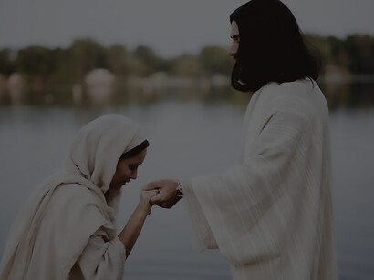 A female, dressed in a biblical gown, clasps the hand of a saint in a serene moment