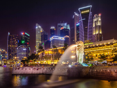 Singapore’s skyline at night, illuminated by its towering buildings