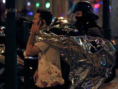 A man is escorted away from the Bataclan concert hall. Photograph: Etienne Laurent/EPA