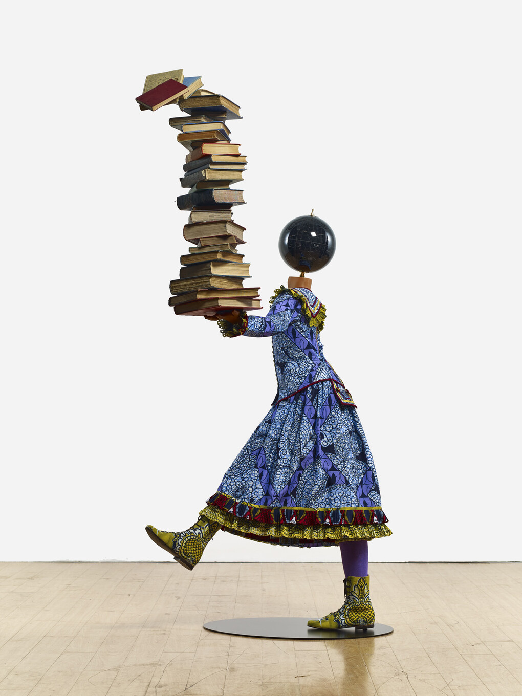 Yinka Shonibare MBE b. 1962, Girl Balancing Knowledge (2015)
Fibreglass mannequin, Dutch wax printed cotton textile, books, globe and steel baseplate
179 x 139 x 89 cm (70 1/2 x 54 3/4 x 35 in.)
Photographer: Stephen White
Image courtesy the artist, Stephen Friedman Gallery,
London and Pearl Lam Galleries, Hong Kong, Shanghai
and Singapore
