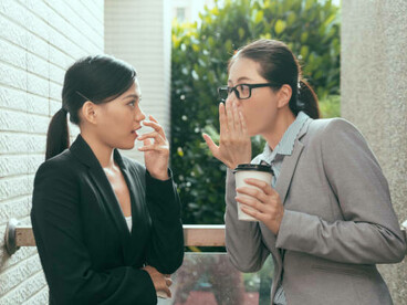 Asian women gossiping and judging, highlighting immigrant loneliness in Europe and the feeling of being out of place