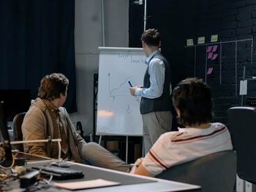 Startup professionals discussing growth strategies, reflecting the culture of continuous iteration that powers lean organizations