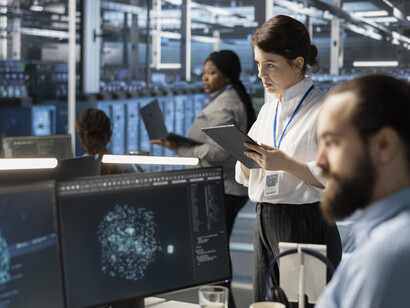 Data center engineer monitoring AI-generated software logs and performance metrics