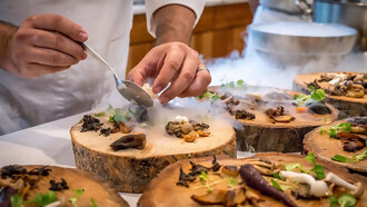 A culinary maestro meticulously assembles a vibrant vegetable dish, arranging the colorful medley with precision on a rustic tree slab, transforming the act of preparation into an artful display of culinary craftsmanship