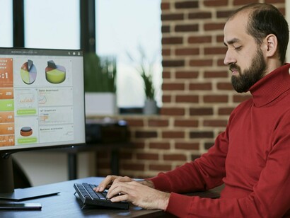 A specialist analysing dashboards filled with performance indicators, symbolising the use of data to optimise audience engagement