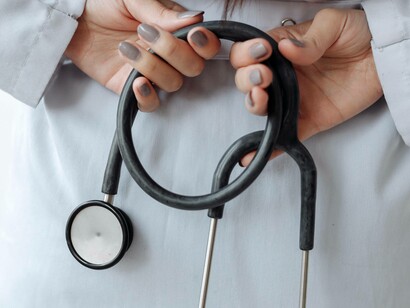 A doctor relying on a stethoscope rather than a chatbot