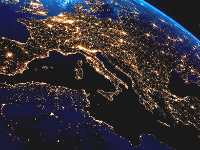 A view of Earth at night showcasing the extensive satellite network and communications infrastructure that connect the modern world