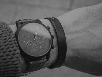 A watch on a man's wrist to help remind him of where he needs to be and when