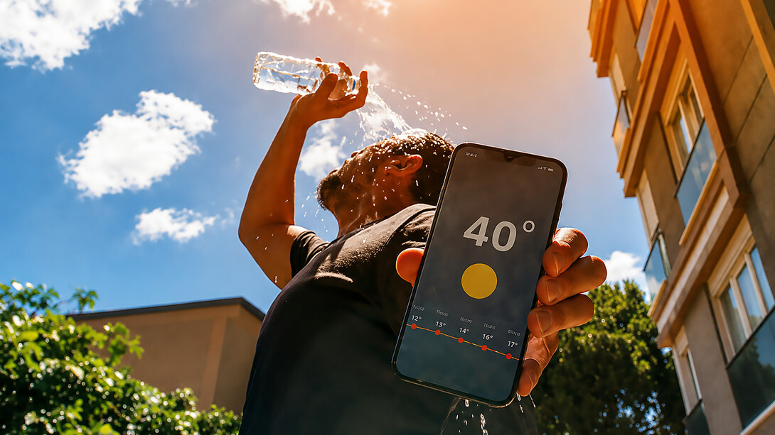 A man cools down with water as temperatures reach 40 degrees Celsius