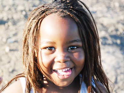 This girl's joyful expression reflects the transformative power of education in empowering youth for a better future