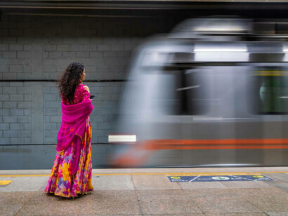 An Indian girl using a mobile phone at a metro station in India