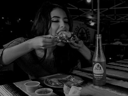 A woman feeding into her desire for junk food considering that desires are a big hurdle, as they distract our minds from reaching our full potential thus not being mindful