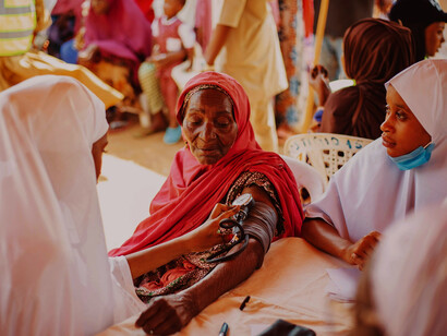 Healthcare workers conducting a community outreach program in Kaduna, Nigeria, underscoring unequal access to basic health services
