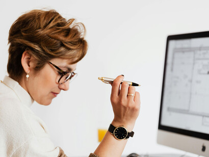 A focused female architect thinking about a business project while working in her office
