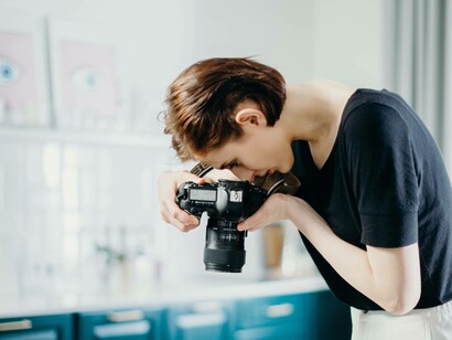 A woman taking a picture to express her creativity