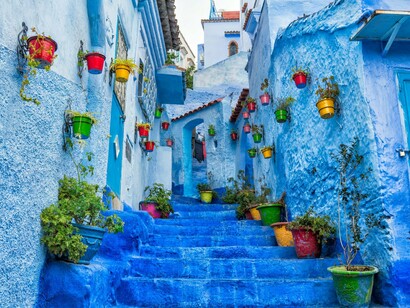 A winding blue alleyway through Tangier in Morocco, reflecting the journey toward self-discovery beyond life's familiar circles