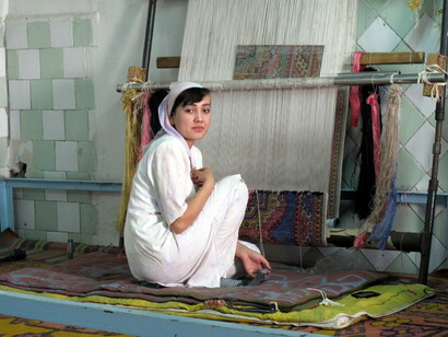 Woman making a silk carpet in a factory in Uzbekistan
