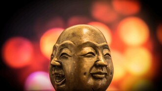 The two faces of Buddha, laughter and happiness