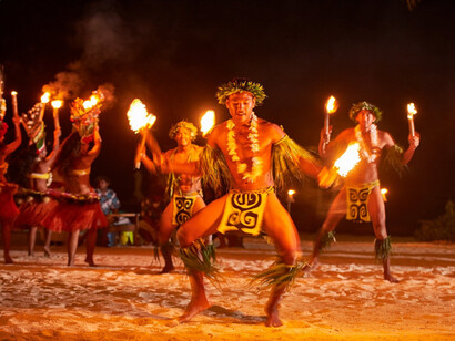 Men carrying fire do a traditional French Polynesian dance in Bora Bora