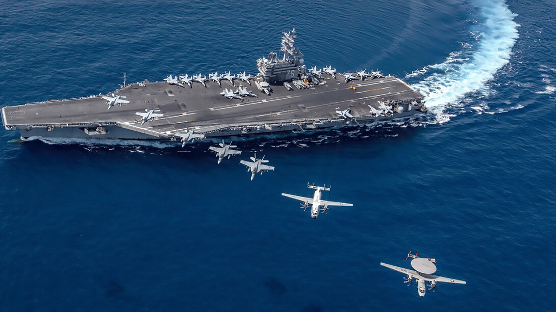 South China Sea  (Oct. 9, 2019), Aircraft from Carrier Air Wing (CVW) 5 fly in formation over the forward-deployed aircraft carrier USS Ronald Reagan (CVN 76), flagship of Carrier Strike Group 5