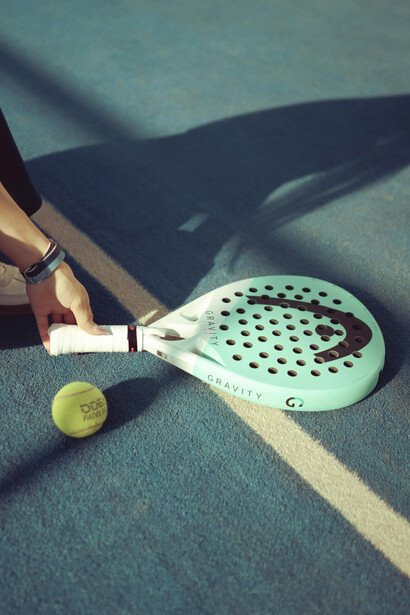 Padel tennis court shadow with racket on indoor glass court