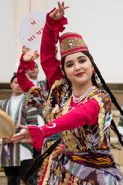 An Uzbek woman performing a national dance showcasing the country’s vibrant cultural traditions