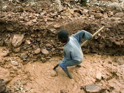 Un niño trabajando en una mina de coltán
