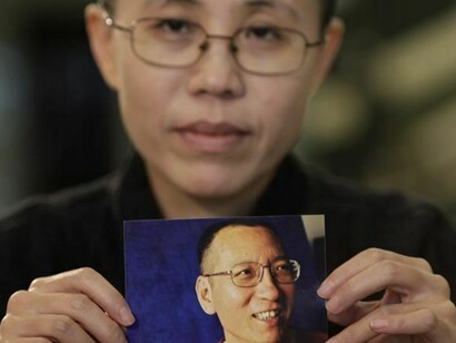 Liu Xia with a photo of her husband