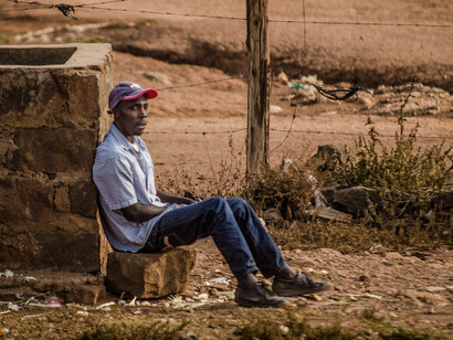 As he sits to rest, his expression tells the story of hard work intertwined with the constant worry of making ends meet in a world that often overlooks the dignity of labour