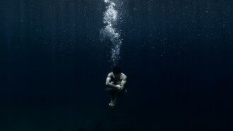 Man sitting underwater 