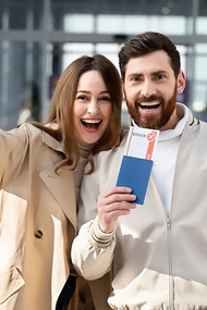 Happy couple with documents and passports preparing to move abroad as expats