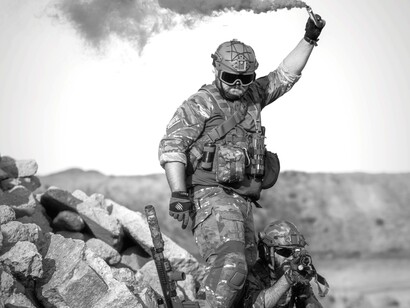 Soldier using a flare gun as a signal