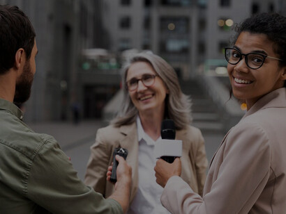 A collective conducting a journalism interview, highlighting collaborative news gathering and communication practices