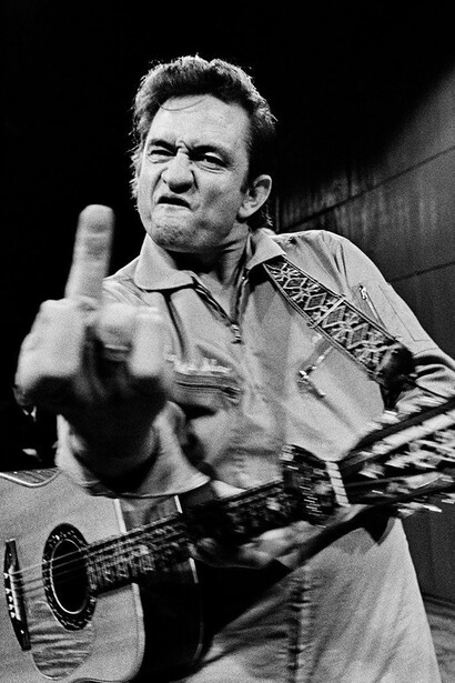Jim Marshall, Johnny Cash, (Flipping the bird), San Quentin Prison, 1969. Courtesy of Fahey/Klein Gallery