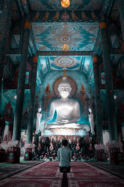 A devoted Indian in a temple, praying to the sacred Buddha, India