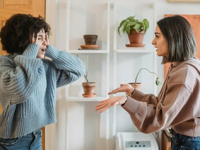 Two women engaged in an animated discussion, representing the importance of dialogue in resolving everyday disagreements