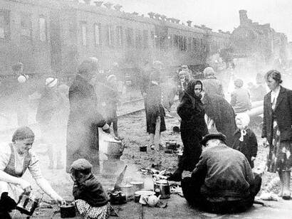 Evacuated residents of Leningrad preparing hot food during a train stop on the journey to Lake Ladoga, Soviet Union