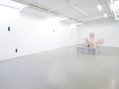 Valentin Carron - Un mur cinq trous, 2014, 5 arrow loopholes, concrete, painting, wood, Variable dimensions - Ravage with granite (after André Tommasini), 2014, Polystyrene and resin, 147 x 162 x 130 cm, View of the exhibition « L’autoroute du soleil à minuit », kamel mennour (47, rue Saint-André des Arts), Paris, 2015 © Valentin Carron, Photo: Fabrice Seixas, Courtesy the artist and kamel mennour, Paris