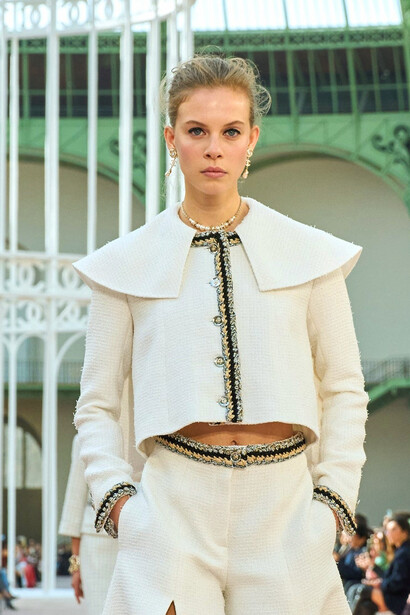 From feather-trimmed hems to oversized collars, the collection celebrates a harmonious balance of tradition and contemporary flair, inviting us to envision a bright, playful future in fashion