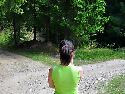 A girl standing at a fork in the road, symbolizing a moment of choice