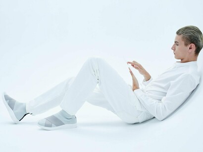 A man sitting silently, completely immersed in his tablet, reflecting the subtle isolation created by constant connectivity